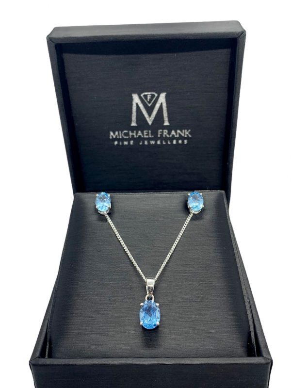 Silver Blue Topaz Oval Cut Pendant and Earring Set